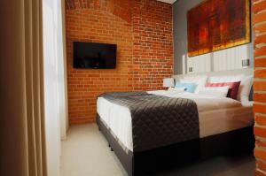 Postel nebo postele na pokoji v ubytování Fabryka Wełny Hotel & Spa