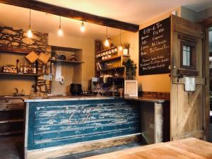 a bar with a large blue door in a restaurant at The Covenanter Hotel in Falkland