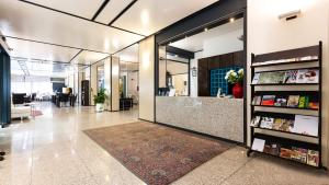 an office lobby with a large glass door at Hotel Lis in Asti