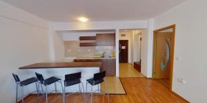 a kitchen with a counter and stools in a room at Magic Costinesti in Costinesti