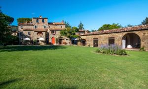 a large yard in front of a stone building at Monastero San Silvestro in Cortona