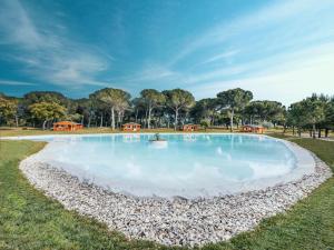 a large pool of water with rocks around it at Chalet do Lago in Montargil