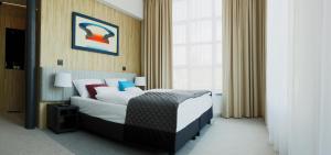 Postel nebo postele na pokoji v ubytování Fabryka Wełny Hotel & Spa