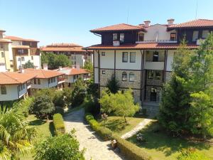 an apartment building in a city with a garden at Etara 1 Apartment Complex in Sveti Vlas