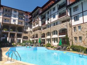 a large swimming pool in front of a building at Etara 1 Apartment Complex in Sveti Vlas