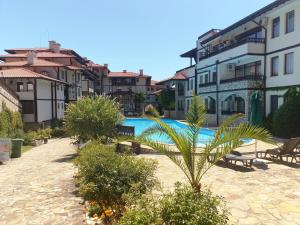 a swimming pool in a courtyard with buildings at Etara 1 Apartment Complex in Sveti Vlas +100 photos
