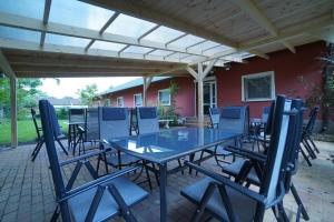 a table and chairs under awning on a patio at Tavi Panzió in Dunapataj