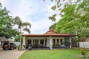 a house with a pitched roof at Hotel Le Green Udawalawe in Udawalawe