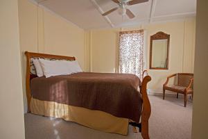 A bed or beds in a room at The Woodbine Inn