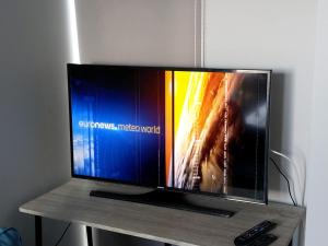 a flat screen tv sitting on top of a table at Elounda Buena Vista Apartment in Elounda