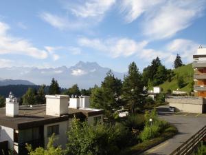 a view of mountains from the roofs of buildings at Roc d'Orsay C15 in Leysin