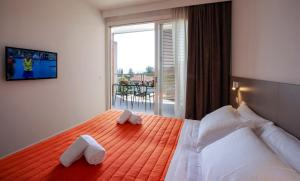 a bedroom with a large bed with towels on it at Residenza Olivo in Garda +39 photos