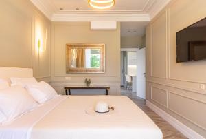 a bedroom with a bed and a flat screen tv at Ormos Luxury Suites Elia in Ormos Panagias