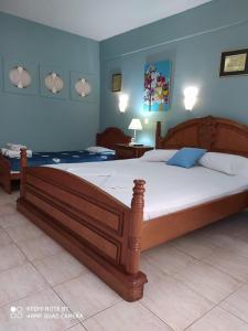 a bedroom with a large wooden bed in a room at House Stella Tasos in Sarti