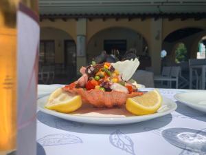 a plate of food with a fish on a table at Vergos Hotel in Vourvourou