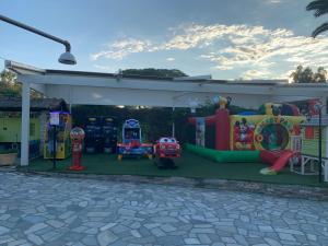 a childrens play area with an outdoor playground at Vergos Hotel in Vourvourou