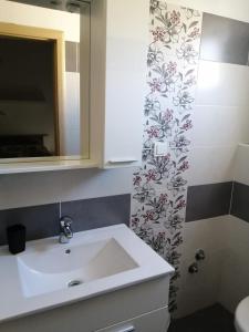 a bathroom with a sink and a shower curtain at Apartment Nana in Supetarska Draga