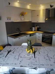 a kitchen with a table with a bowl of fruit on it at Apartment Nana in Supetarska Draga