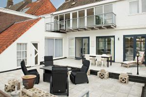 a patio with a table and chairs and a building at Sol Aureus in Middelburg