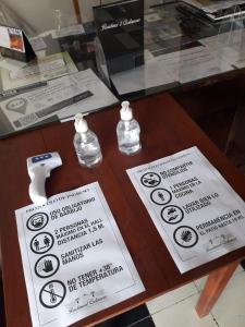 a table with two signs on a glass table at Hotel Costanera in Formosa