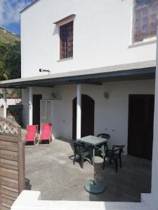 a patio with a table and chairs in front of a house at Casa Morgera in Ischia