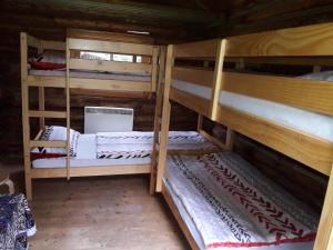a room with three bunk beds in a cabin at Birkenhof Ashram Familien Blockhütten in Hartau