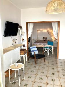un soggiorno con letto e tavolo di VacanzeNaxos - Casa Frontemare a Giardini Naxos