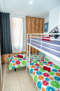 a bedroom with a bunk bed and a bunk bedsheet with flowers at Apartament Central in Lloret de Mar