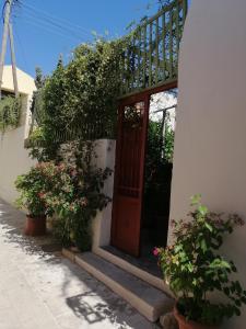 a door of a house with some plants and flowers at "Eirini" traditional house Creta Archanes, Αρχάνες σπίτι in Archanes
