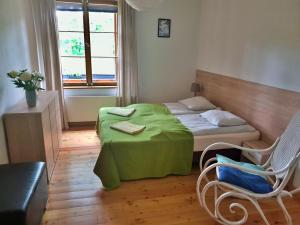 a bedroom with a bed and a table and chairs at Apartament Zieleniec in #N/A