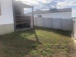 a backyard of a house with a fence at Mount Pleasant Suites in Port Elizabeth