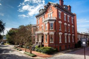 a large red brick building on a city street at Kehoe House, Historic Inns of Savannah Collection in Savannah