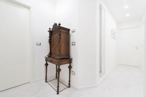 a wooden cabinet on a stand in a room at Ca Marta Venice in Venice