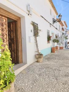 a cobblestone street in a town with white buildings at Casa Celeste in Alicante
