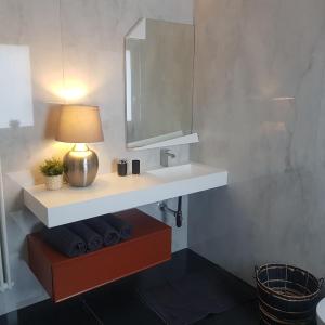 a bathroom with a white sink and a mirror at Borgo antico - FronteMare in Giovinazzo