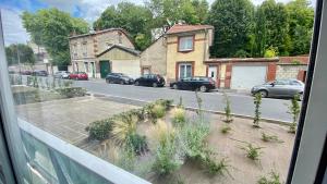 a view from a window of a street with parked cars at Lyloo Studio Epernay in Épernay