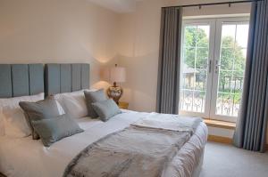 a bedroom with a large bed and a window at Royal Golf Apartments in Dornoch