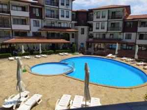 a large swimming pool in front of a building at ARENA Apart Complex in Sveti Vlas