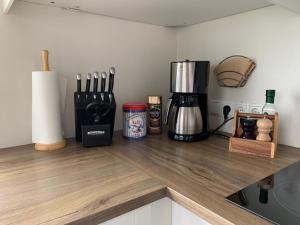 a kitchen counter with a coffee maker on a counter top at Setberg Guesthouse in Nesjum
