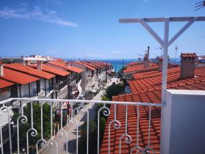 a view of a city with red roofs and the ocean at Gatos House 2 in Pefkohori