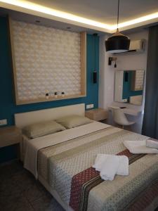 a bedroom with a large bed and a bathroom at Gatos House 2 in Pefkohori