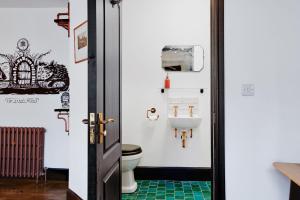 a bathroom with a toilet and a sink at Jet Black Jewel in Whitby