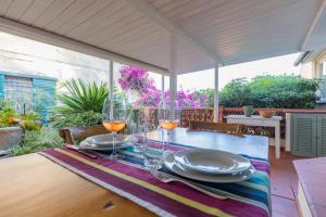 a table with wine glasses and plates on it at Casa di Cosimo by HelloElba in Portoferraio