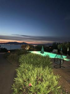 a view of a swimming pool at night at Hotel Celine in Coti-Chiavari