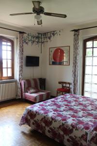 ein Schlafzimmer mit einem Bett, einem Sofa und einem TV in der Unterkunft B&B Casa Sanni in Passignano sul Trasimeno