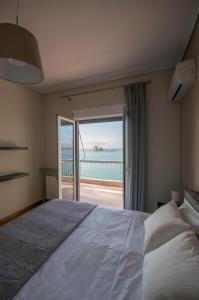 a bedroom with a bed with a view of the ocean at Di fronte alla fortezza in Nafplio