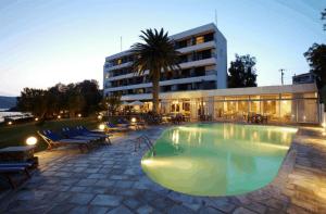 a large swimming pool in front of a building at Apollon Suites in Karistos