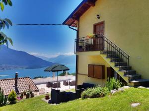 a building with stairs and a view of the water at Casa Margherita Top in Sorico