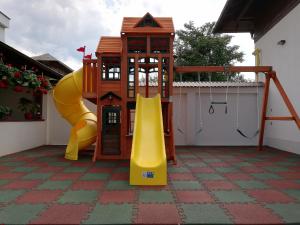 a playground with a slide and a play structure at Hotel Buchenland in Gura Humorului