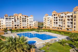 an aerial view of a large apartment complex with a swimming pool at Los Pelicanos by Ĥ - Playa Punta del Moral PLHC39P38 in Isla del Moral